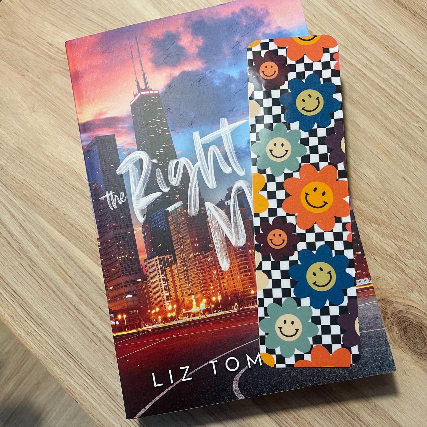 floral checkered bookmark on top of a book on a wooden surface
