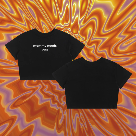 Black crop top with "mommy needs bass" on the front against an orang swirl background