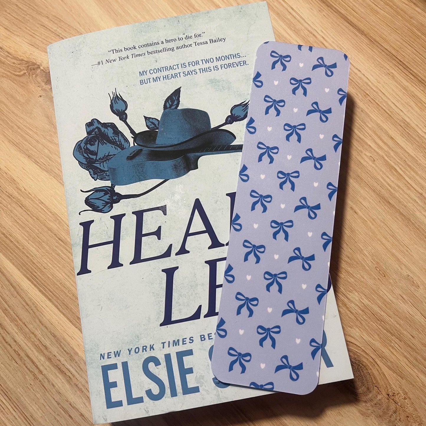blue bookmark on a blue book on a wooden surface