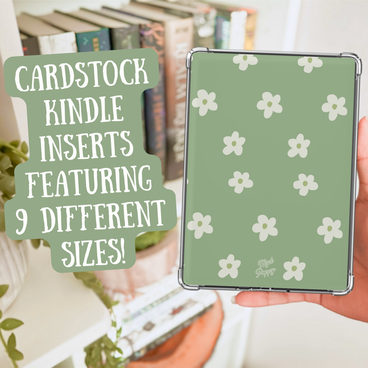 Hand holding a green cardstock Kindle insert with white floral pattern, surrounded by books and plants.