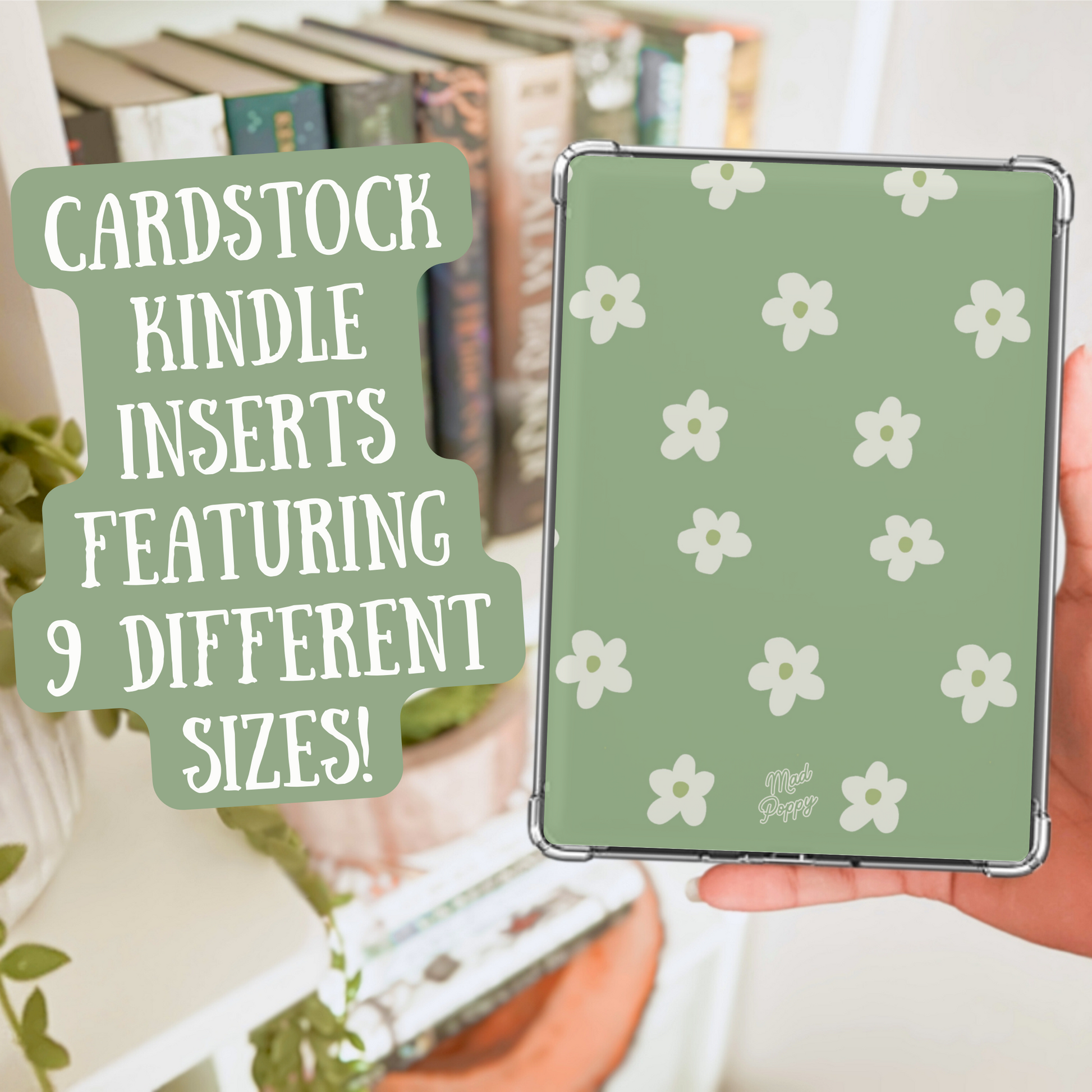 Hand holding a green cardstock Kindle insert with white floral pattern, surrounded by books and plants.