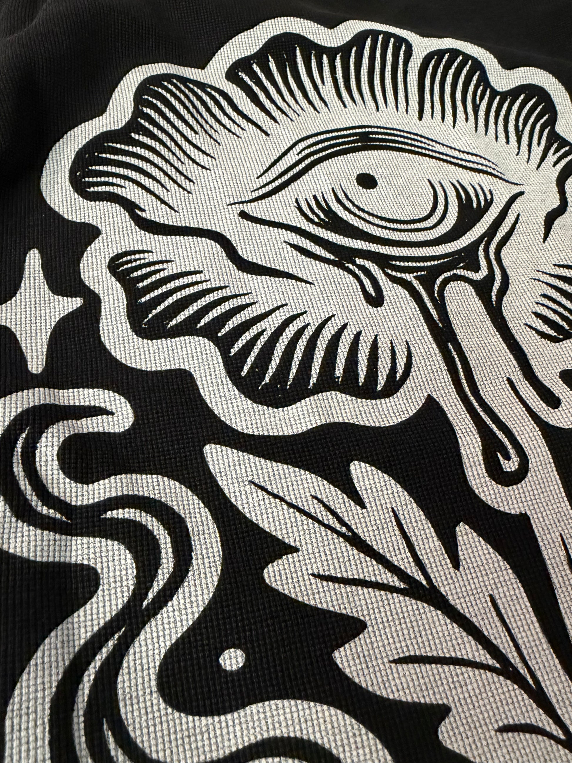 Close-up of a black and white abstract pattern on a textured surface