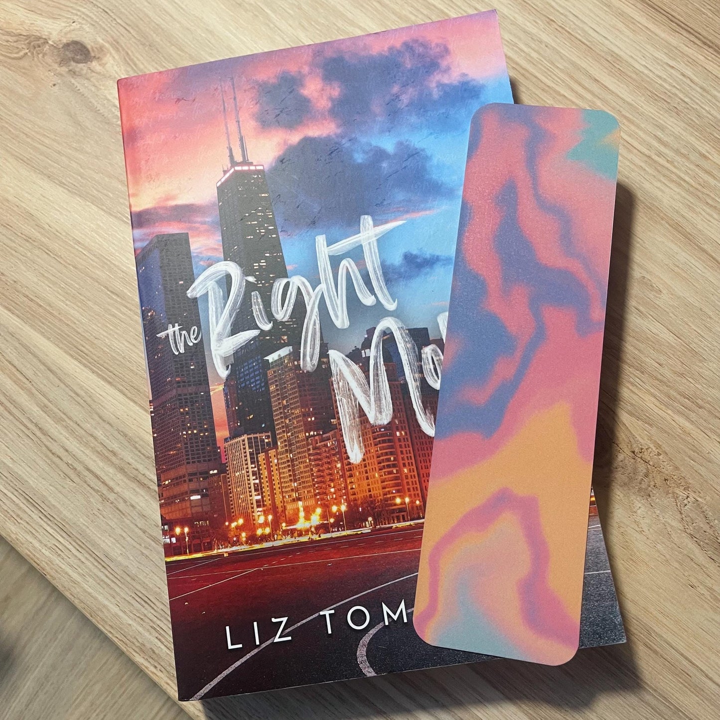 colorful bookmark on top of a book on a wooden surface