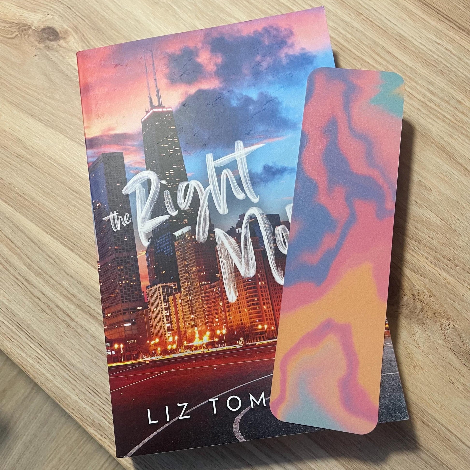 colorful bookmark on top of a book on a wooden surface