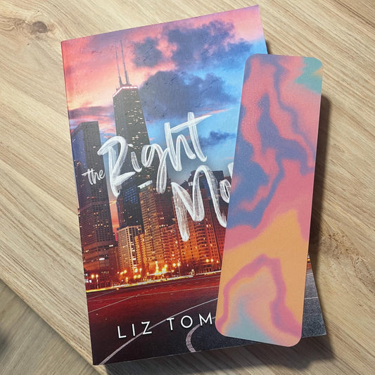 colorful bookmark on top of a book on a wooden surface