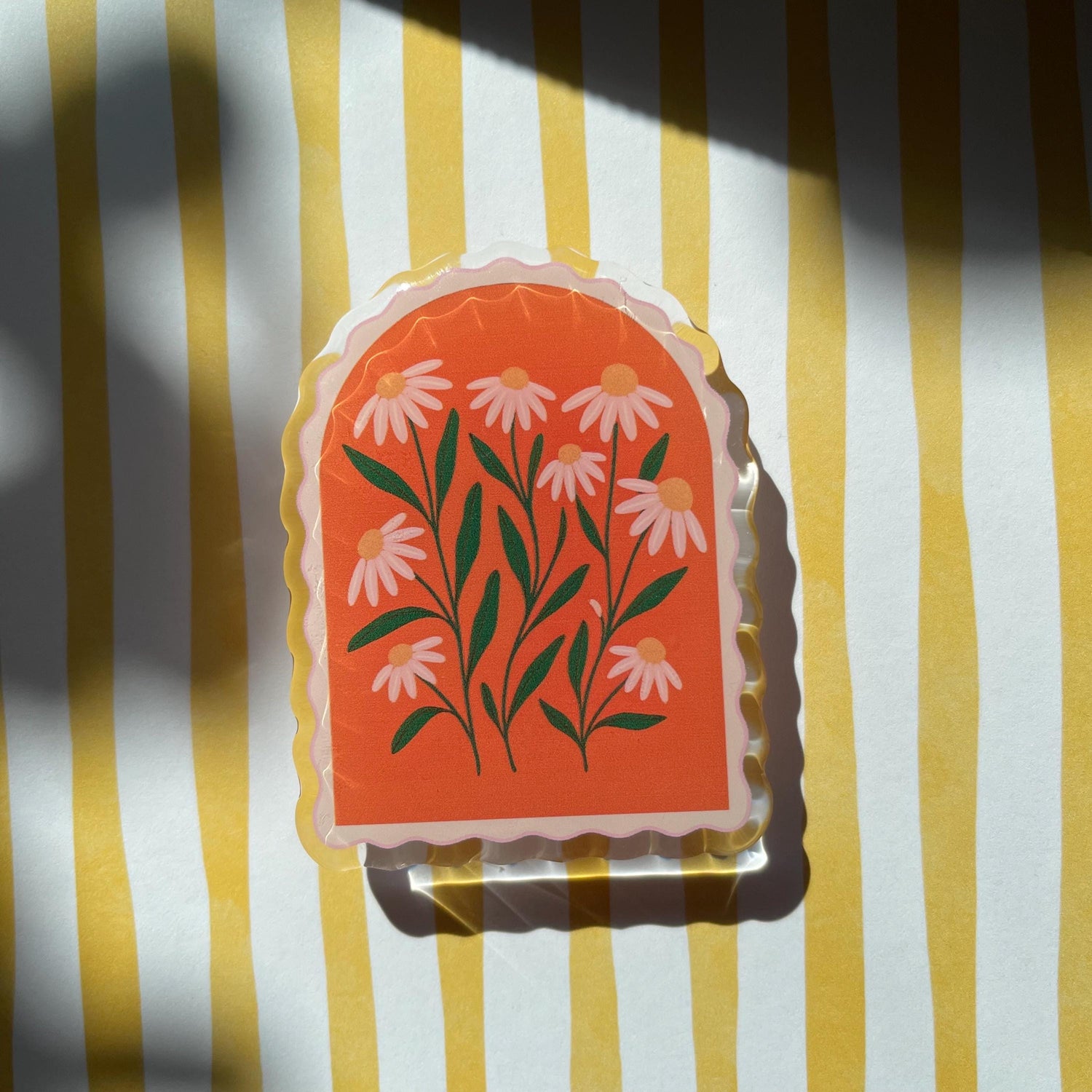 Decorative kindle grip with floral design on a yellow and white striped background