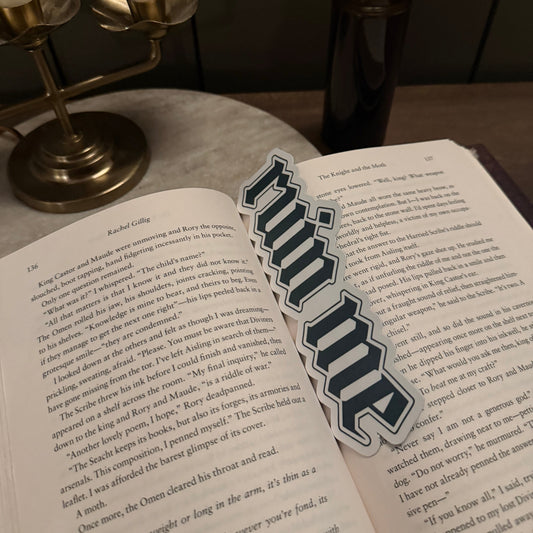 Open book with a sticker labeled 'ruin me' on a wooden surface