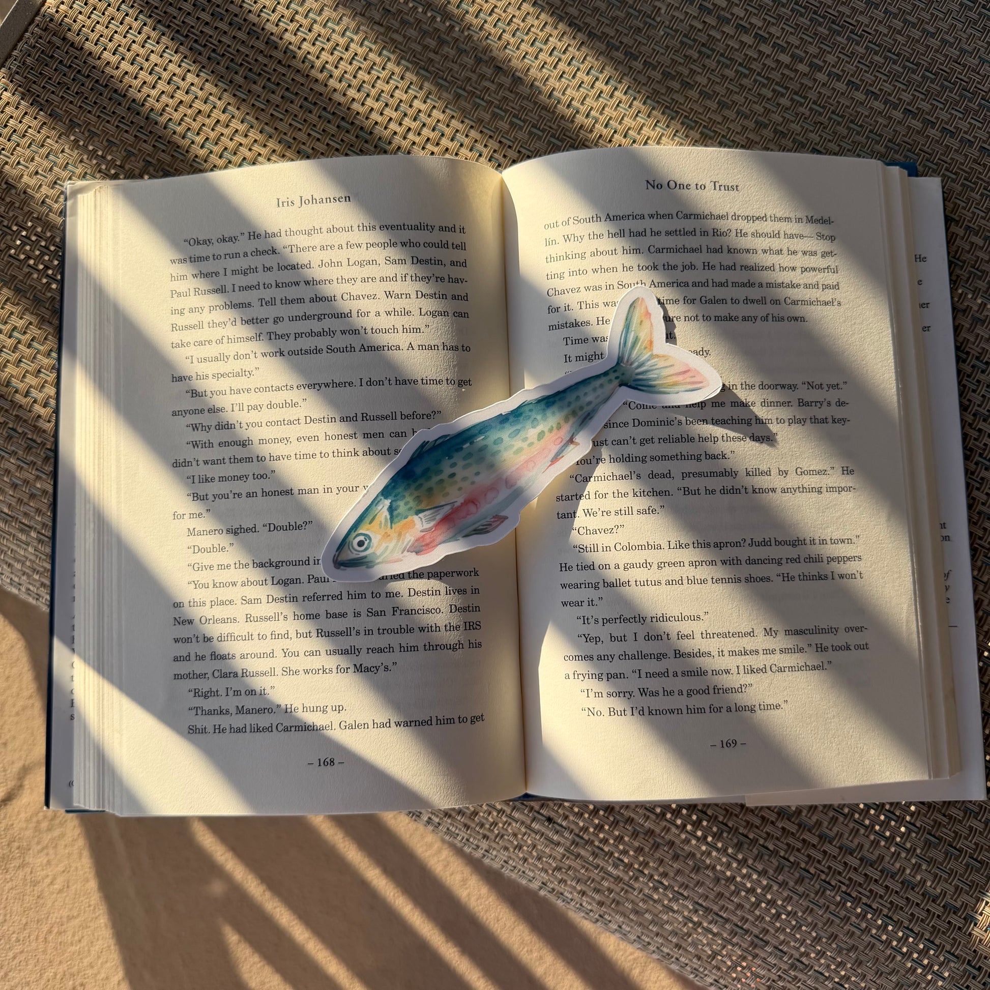 sardine shaped bookmark on an open book