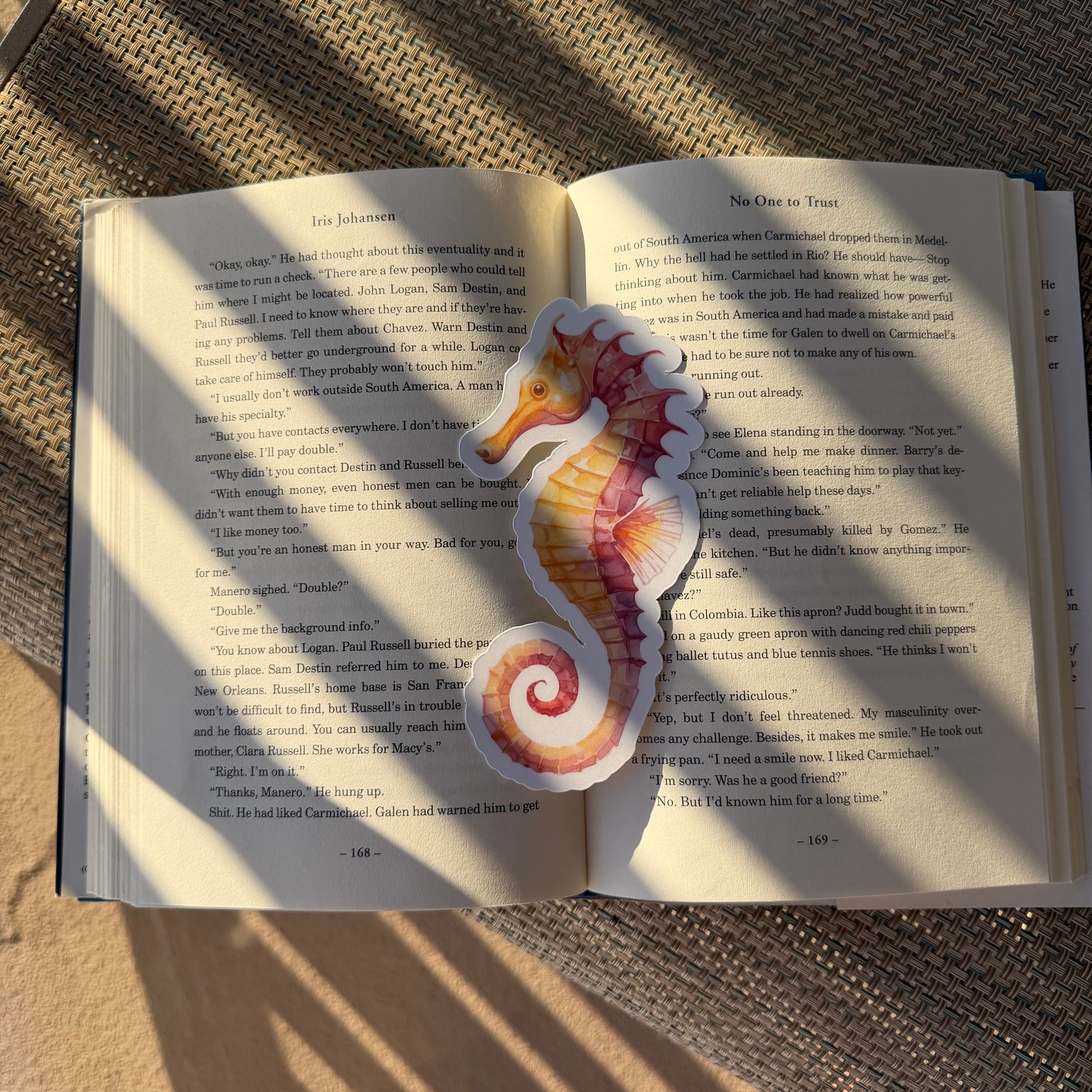 Seahorse-shaped bookmark on an open book