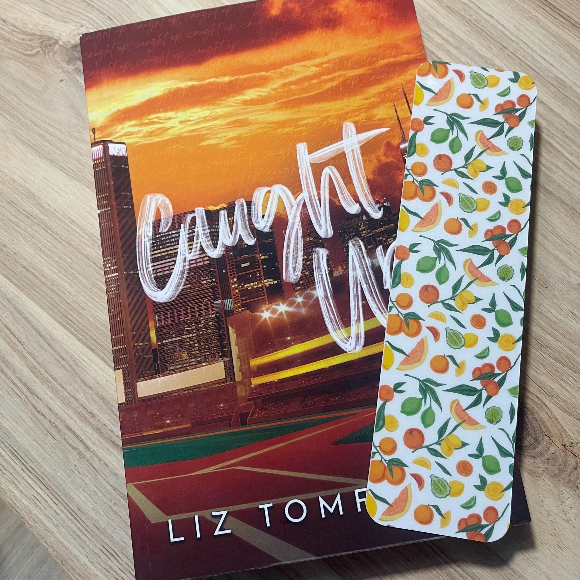 citrus bookmark on top of a book on a wooden surface