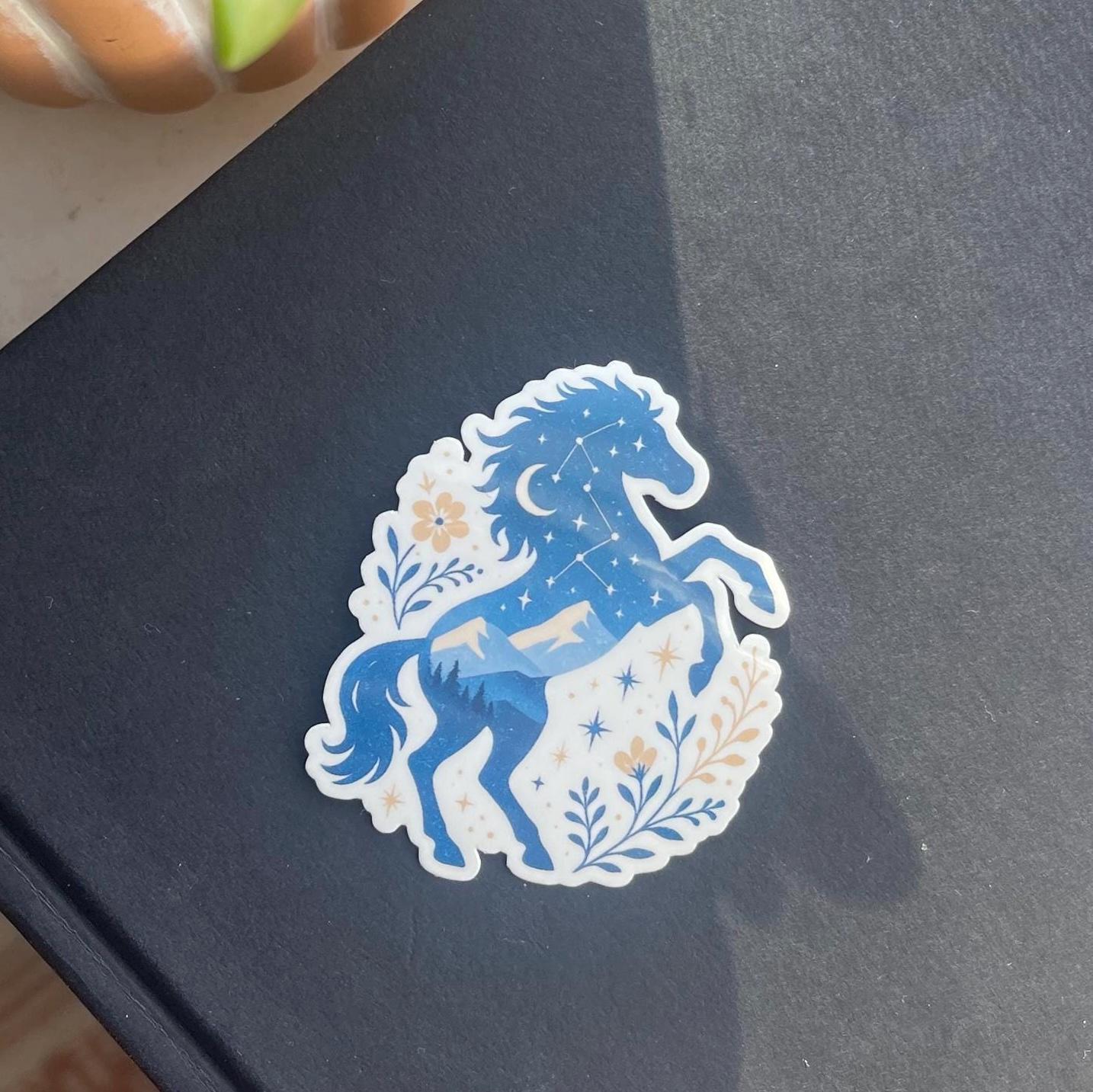 Blue horse design sticker on a dark surface